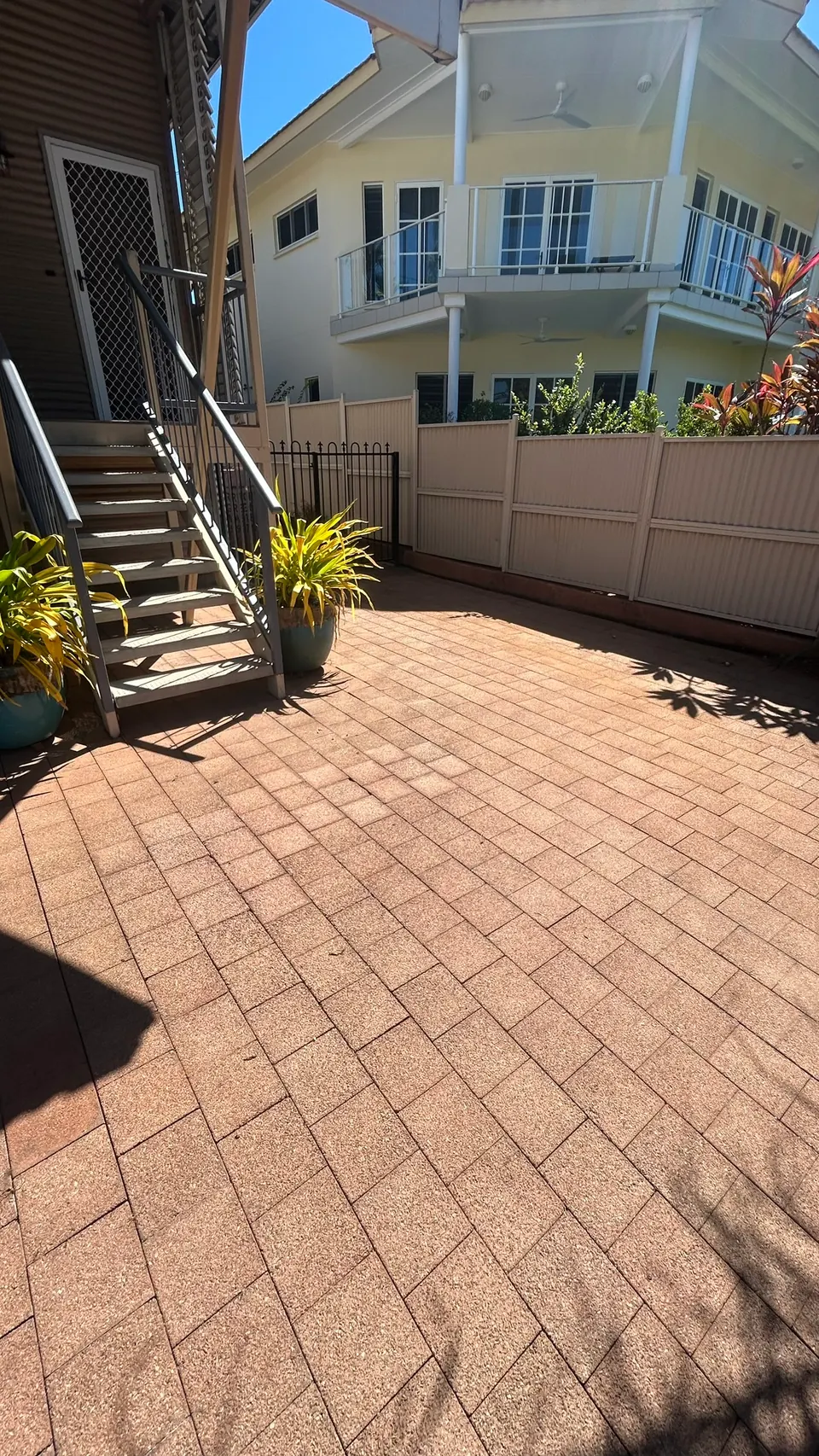 Courtyard pavers and gate area after pressure washing