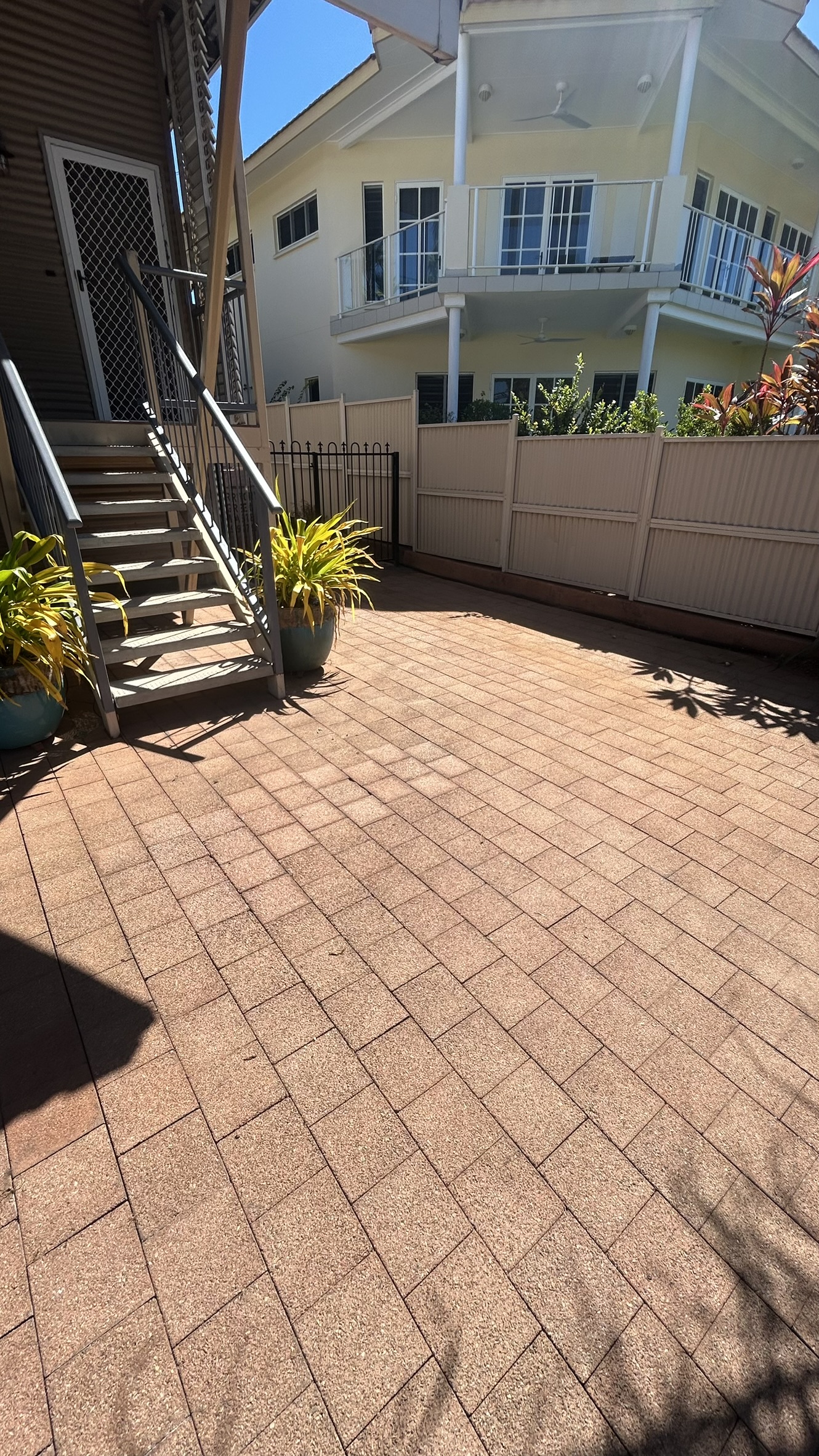 Courtyard pavers and gate area after pressure washing